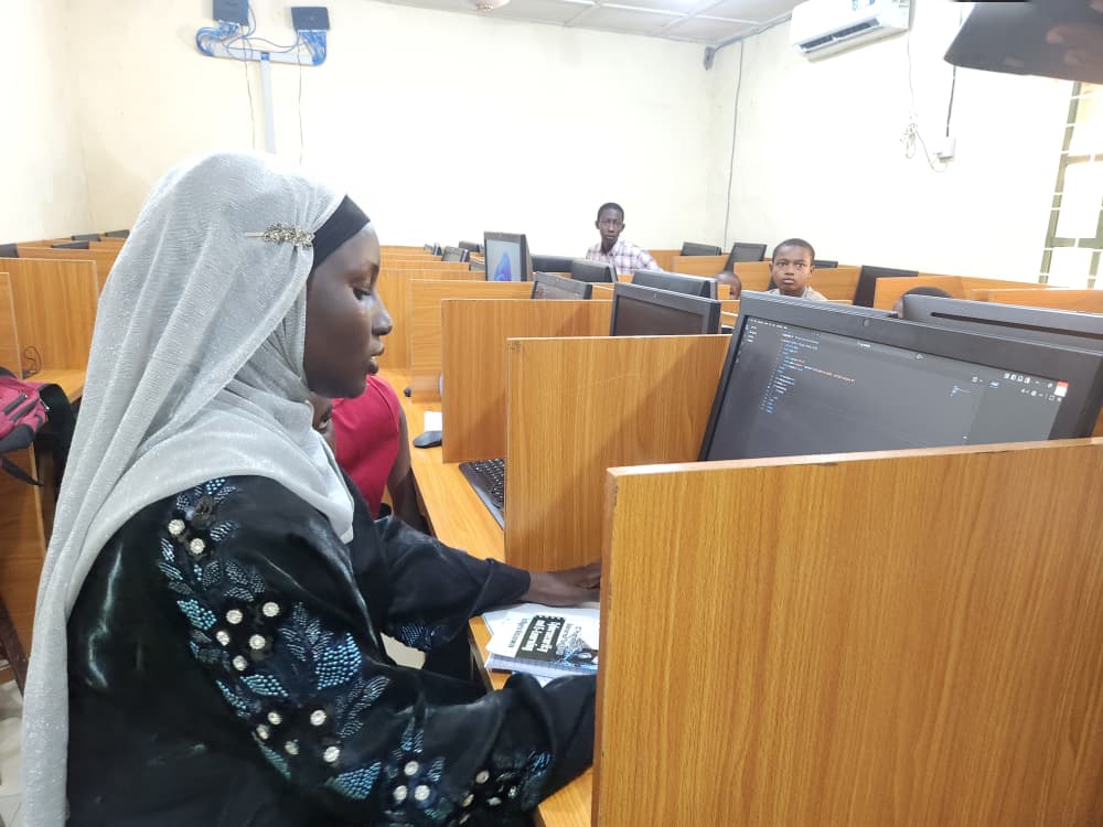 Syncbright learner writing code in the Yola training lab